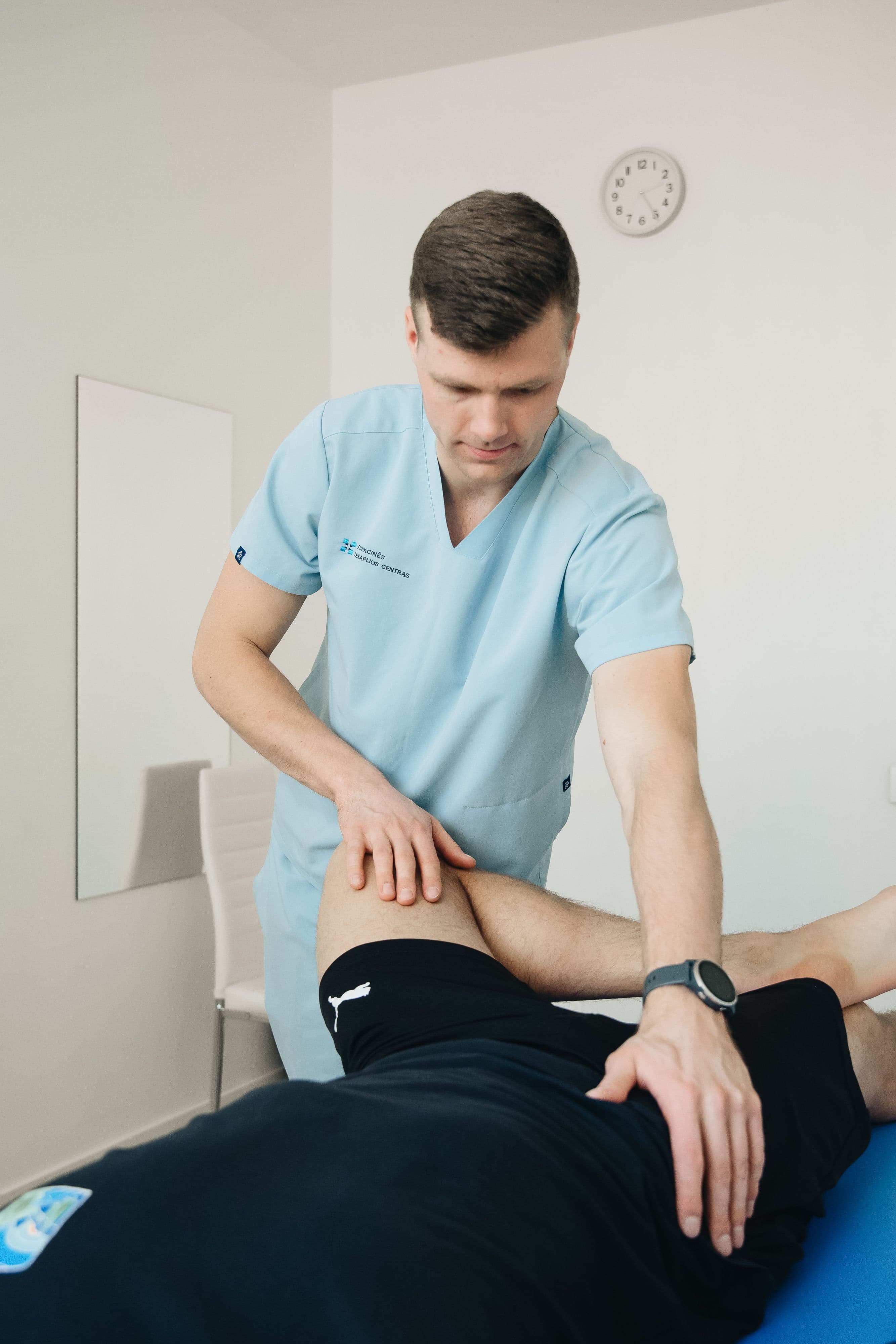 A physiotherapist assessing a patient's knee mobility